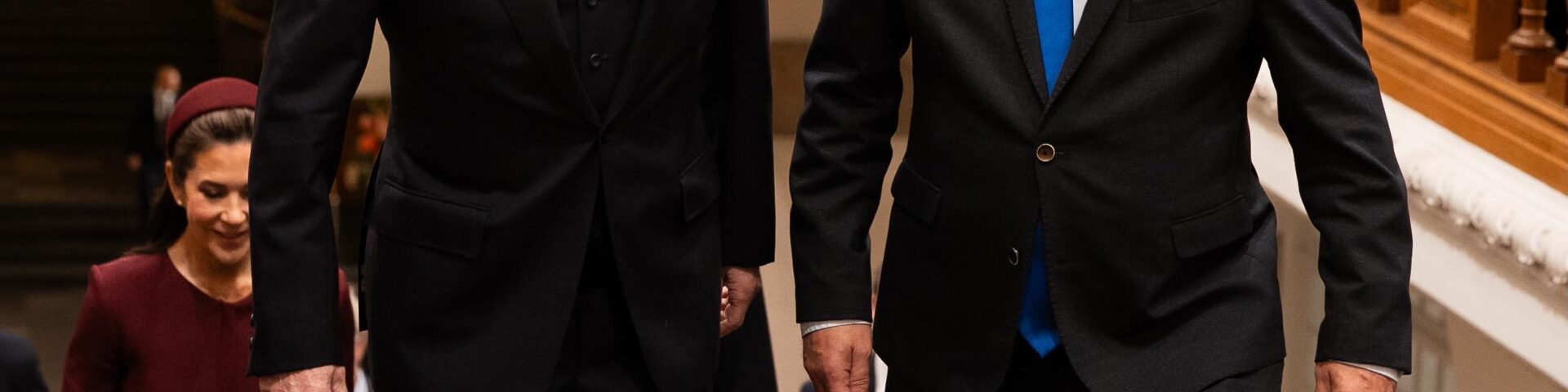 King Frederik X of Denmark and Folketinget Speaker Henrik Frandsen walk down the staircase at the opening of the Danish Parliament, followed by Queen Mary in burgundy — Photo: Kongehuset