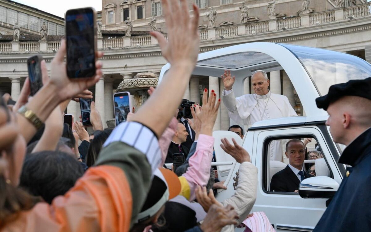Pope Leo XIV in white cassock waving from the white popemobile to families and pilgrims in St Peter's Square, Vatican City, during the General Audience - Photo: @pontifex